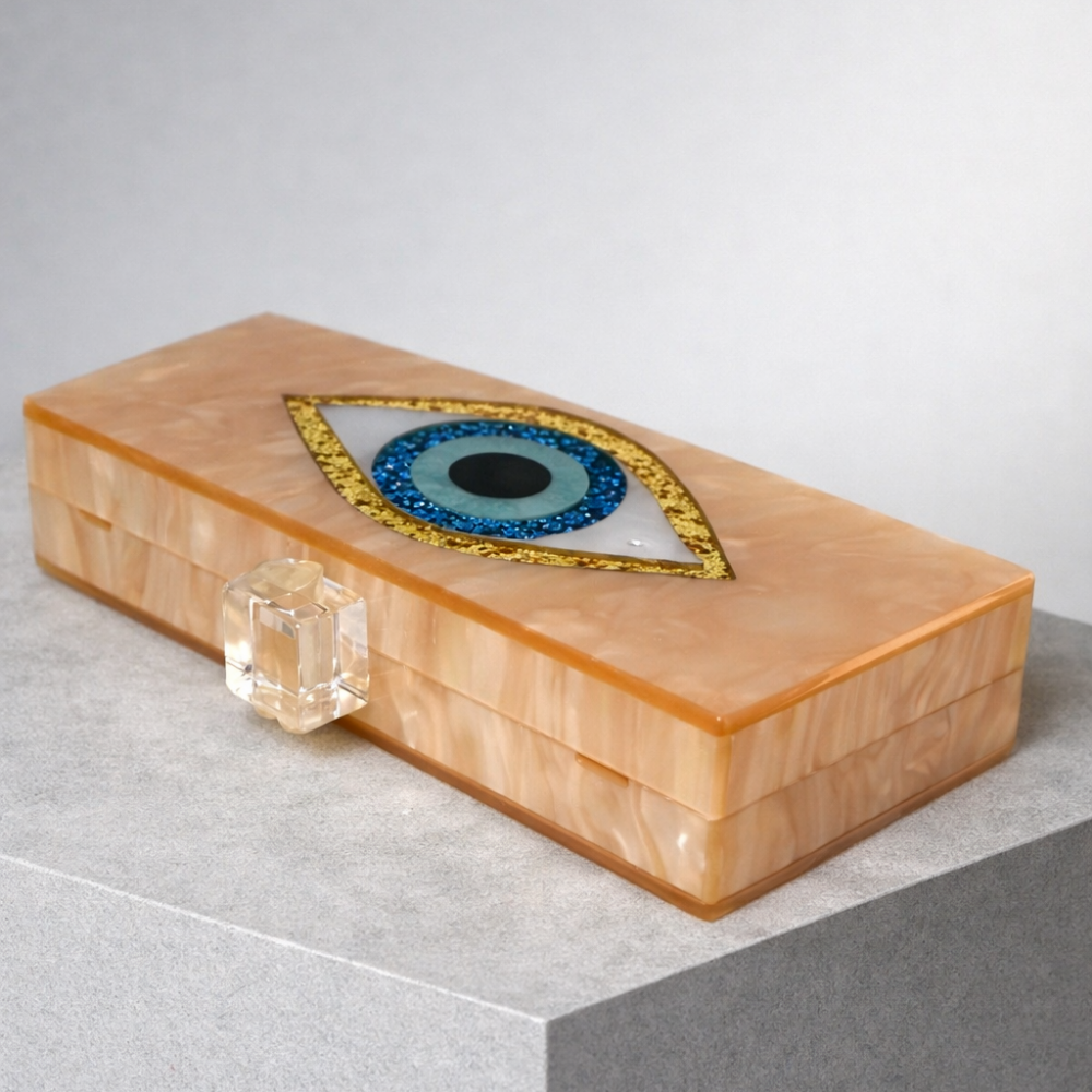 Rectangular box with an eye design on a gray surface