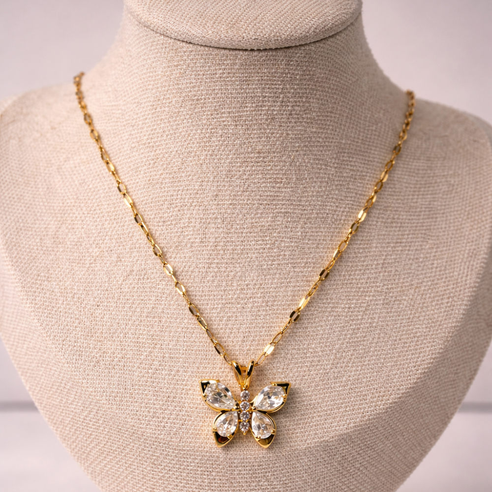 Gold butterfly necklace on a mannequin bust