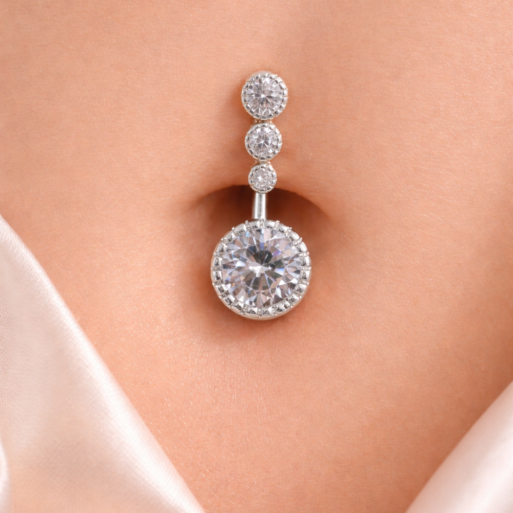 Rihnstone belly-button piercing on a model's belly-button with a soft background