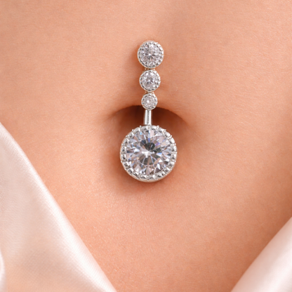 Rihnstone belly-button piercing on a model's belly-button with a soft background