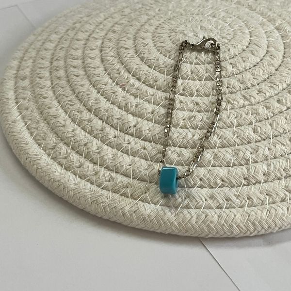 White chain and turquoise bracelet