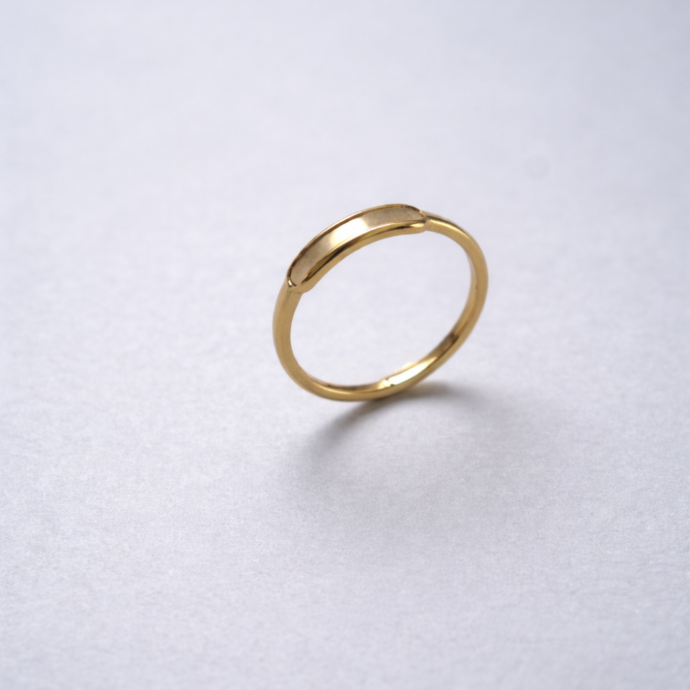 Gold ring on a light gray background