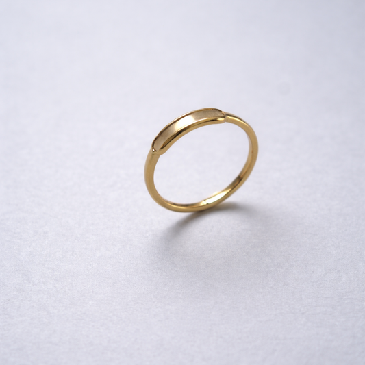 Gold ring on a light gray background