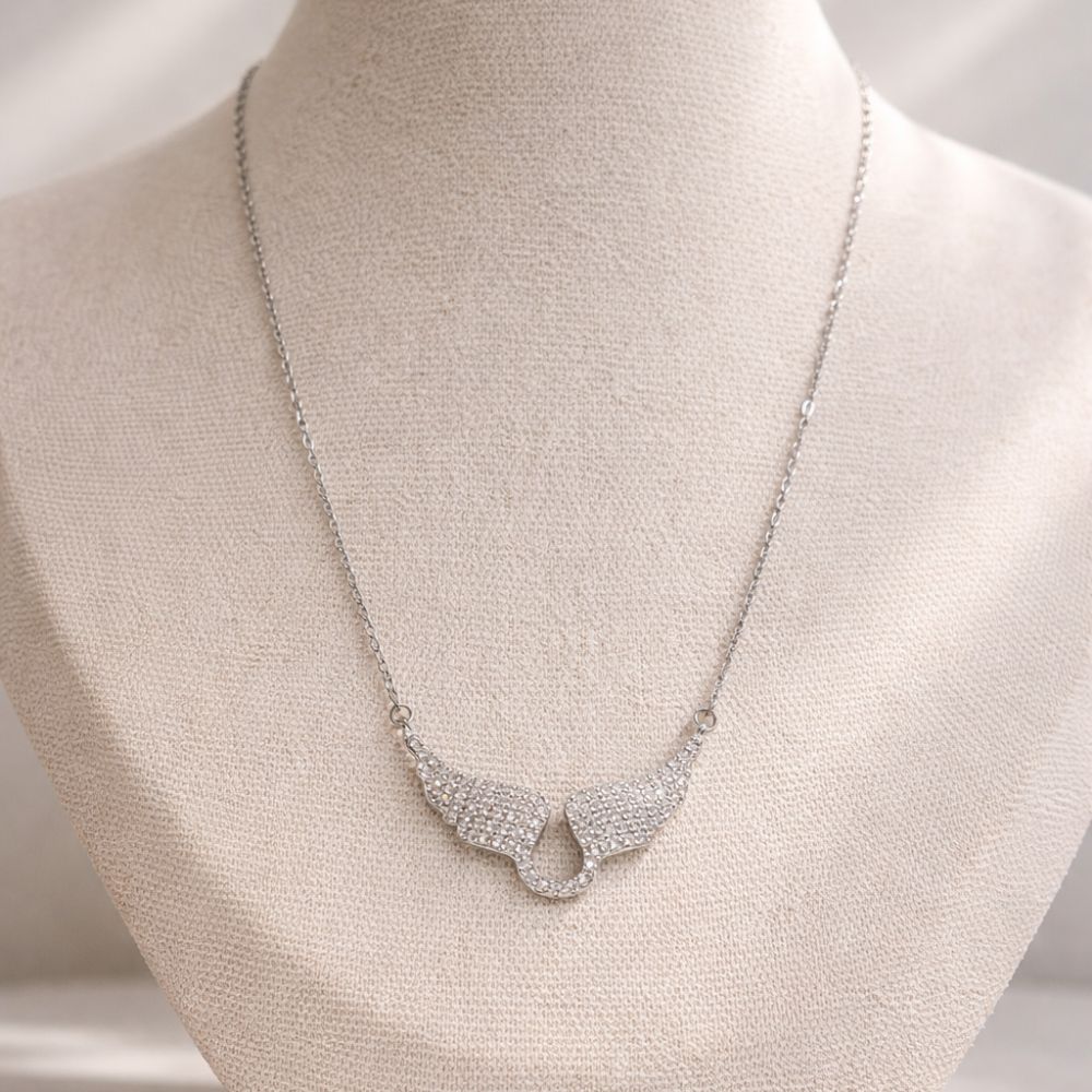 Silver necklace on a mannequin bust with a neutral background