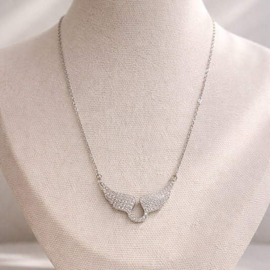 Silver necklace on a mannequin bust with a neutral background