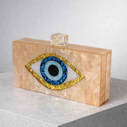 Clutch bag with eye design and beige marble texture on a light gray background