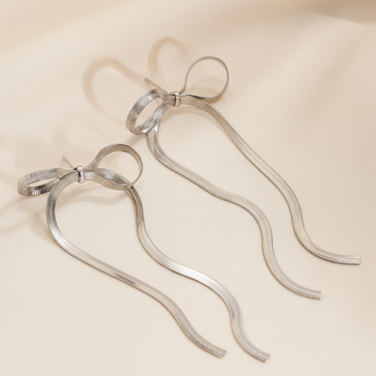 Two silver metal straws on a beige background