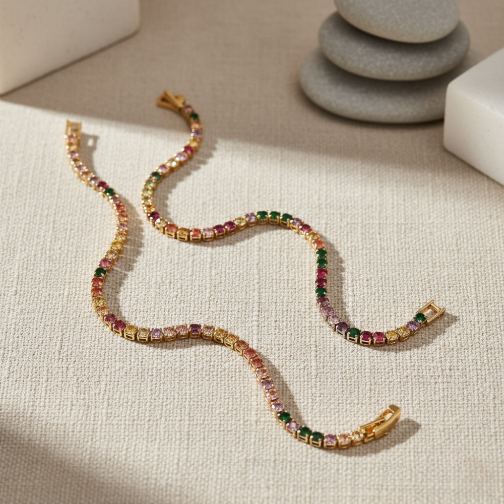 Multicolored tennis bracelets on a textured surface