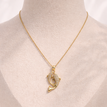 Gold necklace with a unique pendant on a mannequin.