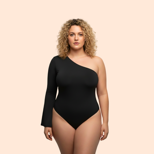Woman wearing a black one-shoulder bodysuit on a beige background