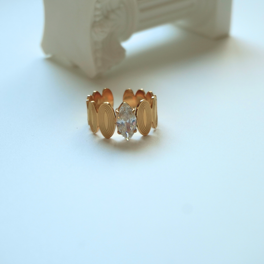 Gold ring with a diamond on a light blue background