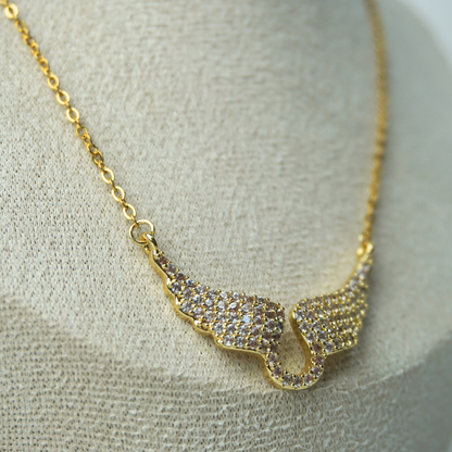 Gold necklace with a unique pendant on a textured surface
