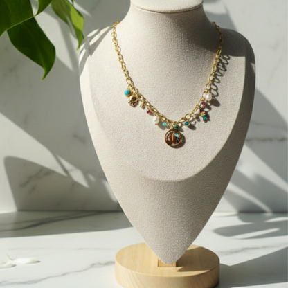 Necklace with colorful charms on a mannequin bust with a light background