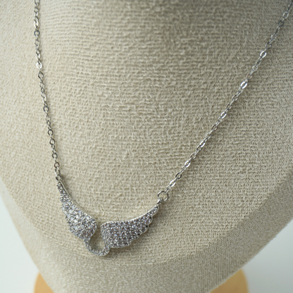 Silver necklace on a mannequin bust with a neutral background
