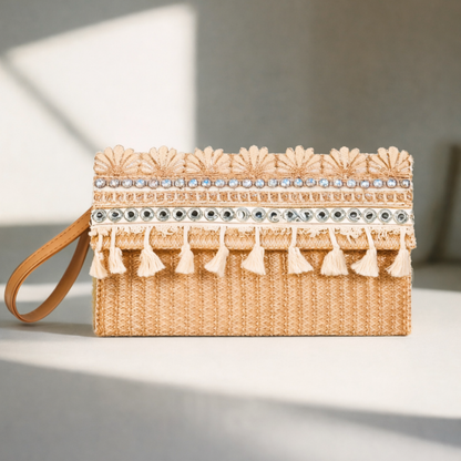 Woven clutch with decorative tassels and beads on a neutral background