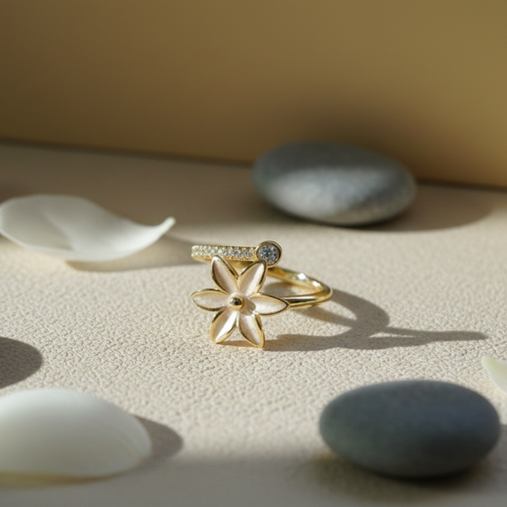 Gold ring with a floral design on a textured surface