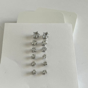 Star shaped stud earrings - 7 pairs silver colored