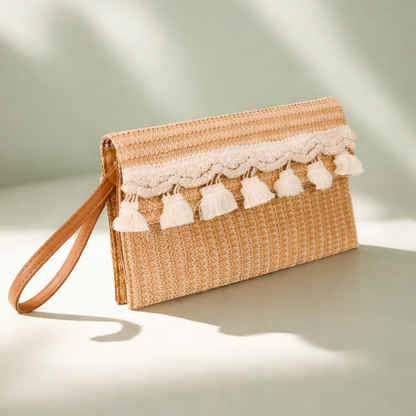Woven clutch bag with lace and tassel details on a light background