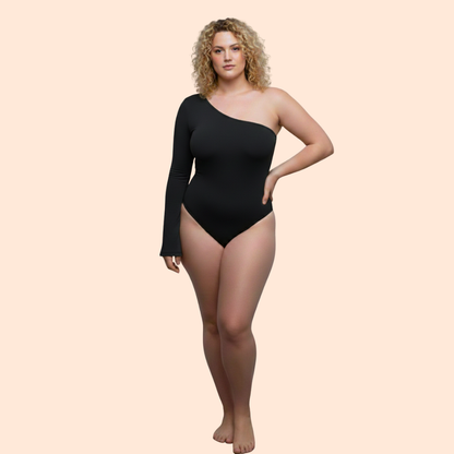 Woman wearing a black one-shoulder bodysuit on a beige background