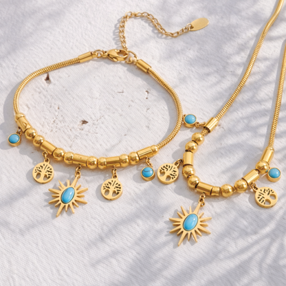 Gold bracelet with turquoise stones on a textured white surface